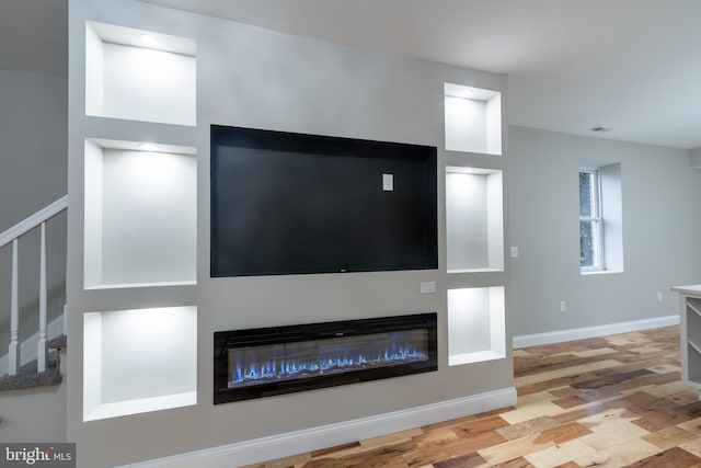 unfurnished living room featuring light hardwood / wood-style floors