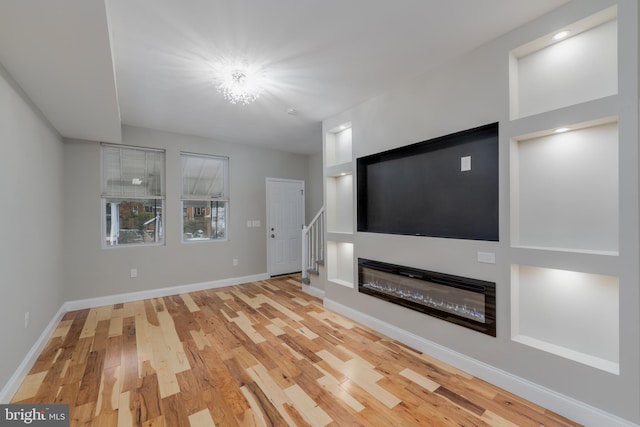 unfurnished living room featuring wood-type flooring