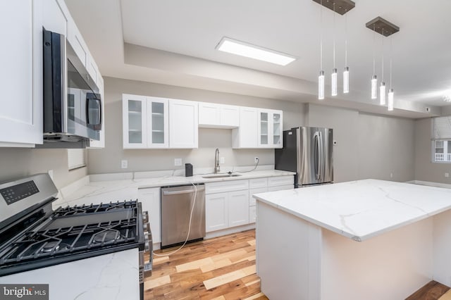 kitchen featuring white cabinets, light stone countertops, sink, and stainless steel appliances