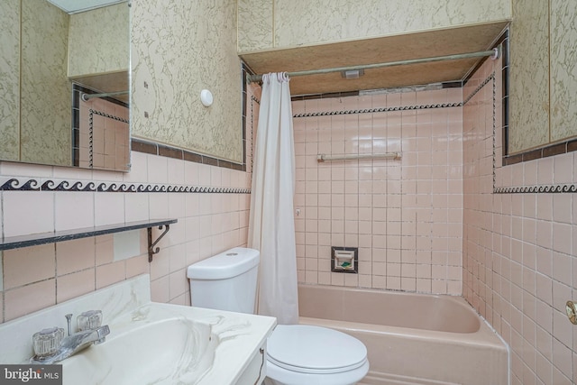 full bathroom featuring shower / tub combo with curtain, vanity, tile walls, and toilet