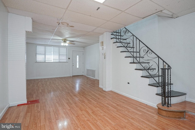 entrance foyer with light wood-type flooring, a drop ceiling, and ceiling fan