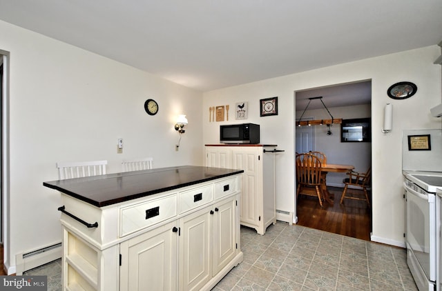 kitchen featuring white range with electric stovetop, a center island, white cabinetry, and a baseboard heating unit