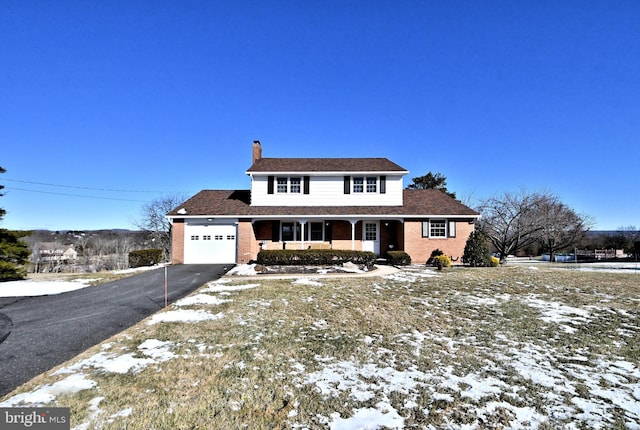 view of front of house with covered porch and a garage