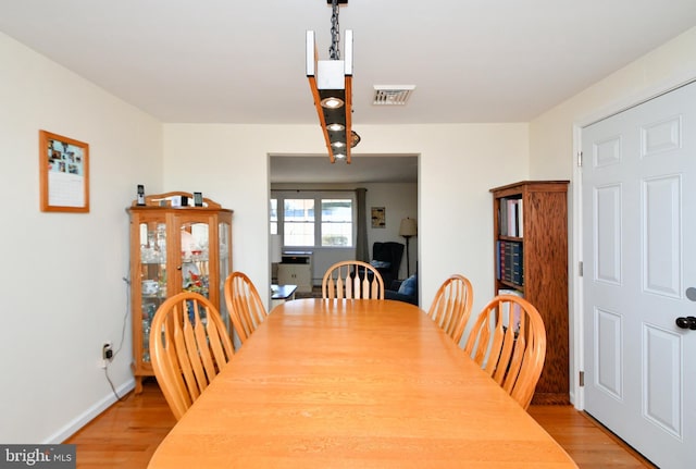 dining space with light hardwood / wood-style flooring