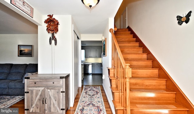 staircase with hardwood / wood-style flooring