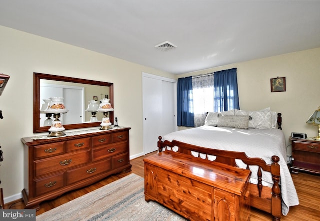 bedroom with hardwood / wood-style flooring and a closet