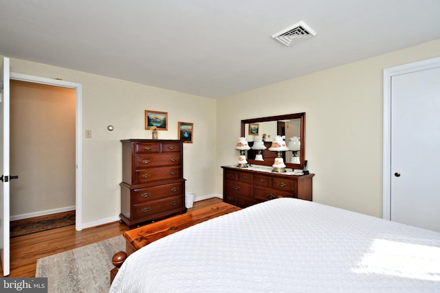 bedroom with wood-type flooring