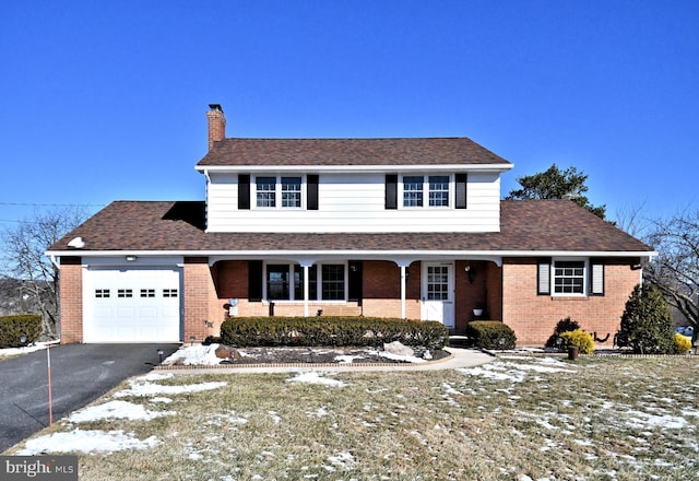 front of property featuring a porch and a garage