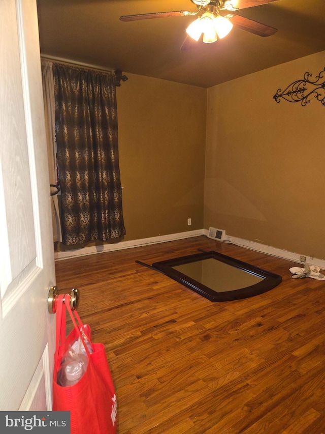 interior space with hardwood / wood-style flooring and ceiling fan