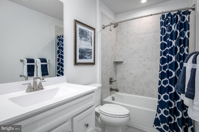 full bathroom with vanity, shower / bath combo, and toilet