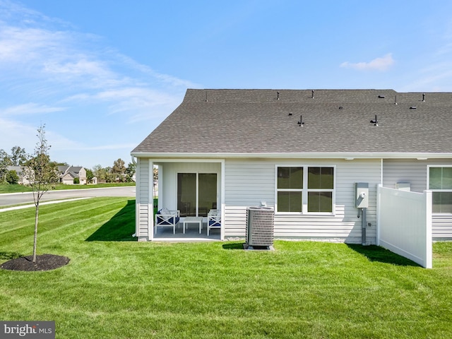 rear view of house featuring central AC, a yard, and a patio area