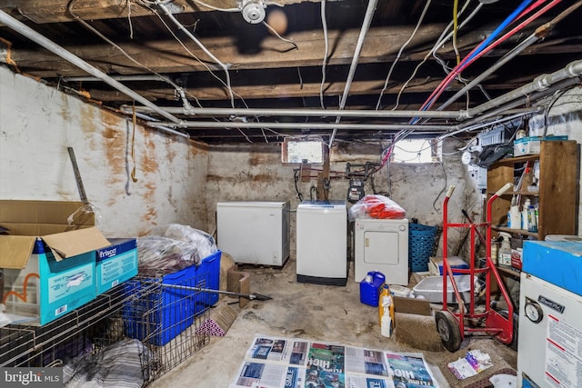 basement featuring refrigerator and washer and dryer