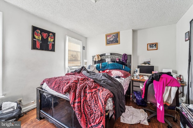 bedroom featuring hardwood / wood-style flooring and a textured ceiling