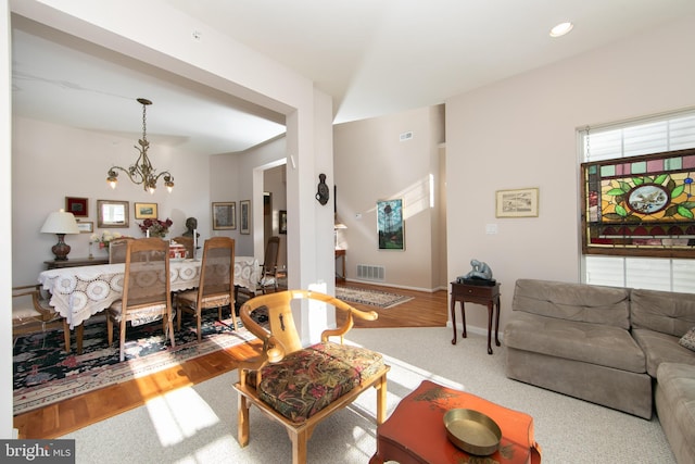 living room featuring a chandelier and hardwood / wood-style flooring