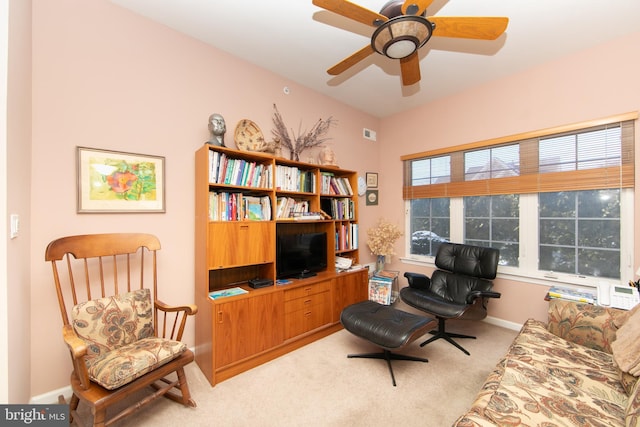 living area with ceiling fan and light colored carpet