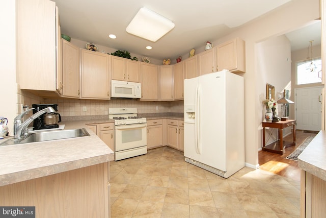 kitchen with tasteful backsplash, light brown cabinets, white appliances, and sink