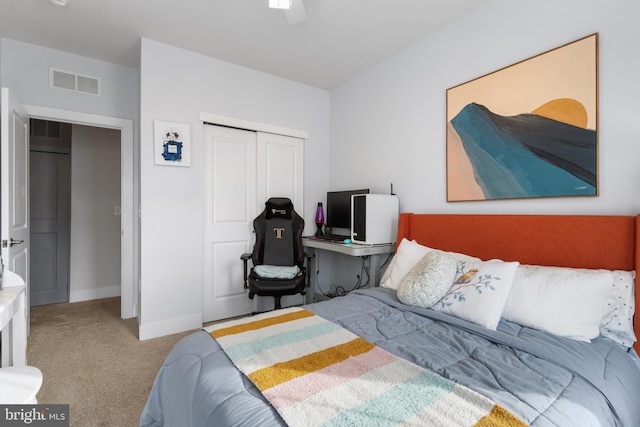 carpeted bedroom with ceiling fan and a closet