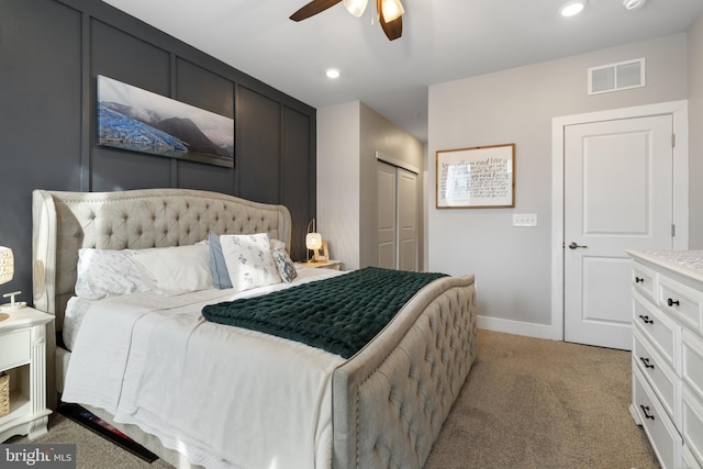 carpeted bedroom with ceiling fan and a closet