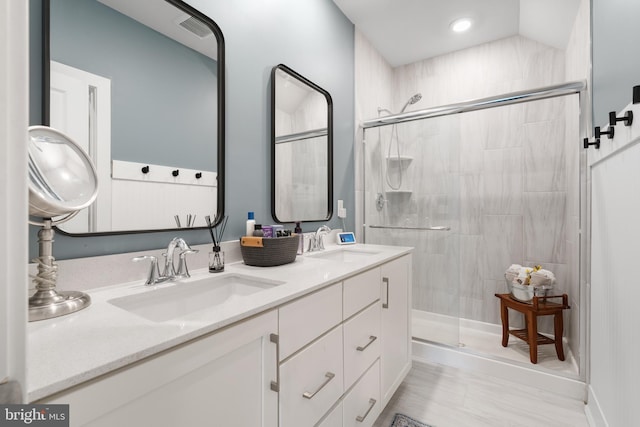 bathroom with vanity and a shower with shower door