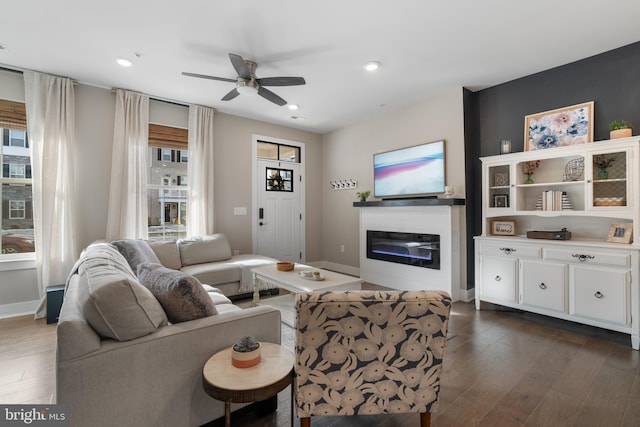 living room featuring dark hardwood / wood-style floors and ceiling fan