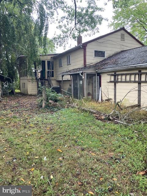 rear view of property with a sunroom