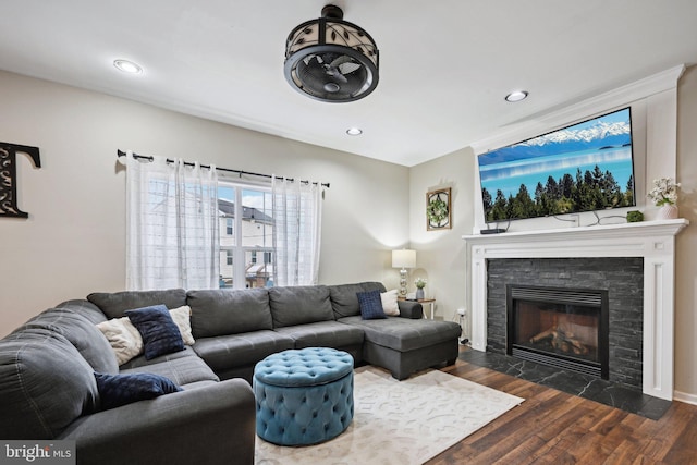 living room with dark hardwood / wood-style flooring and a fireplace