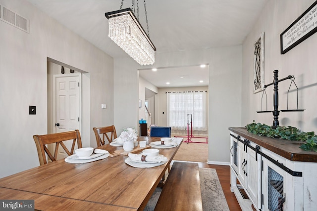 dining area with a chandelier and hardwood / wood-style flooring