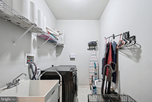 washroom featuring washing machine and dryer and sink