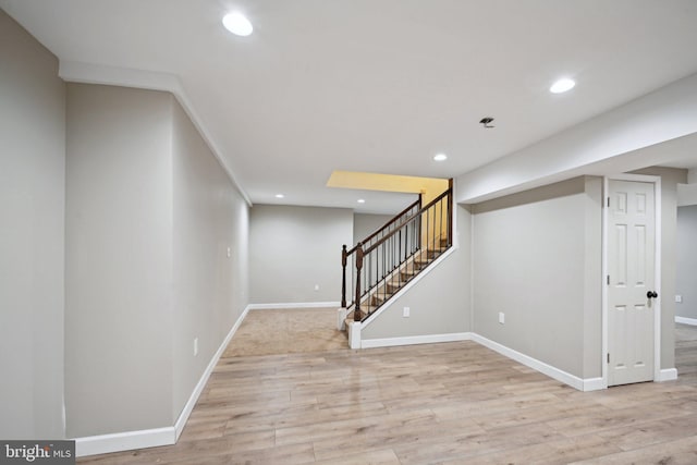 basement with light hardwood / wood-style flooring