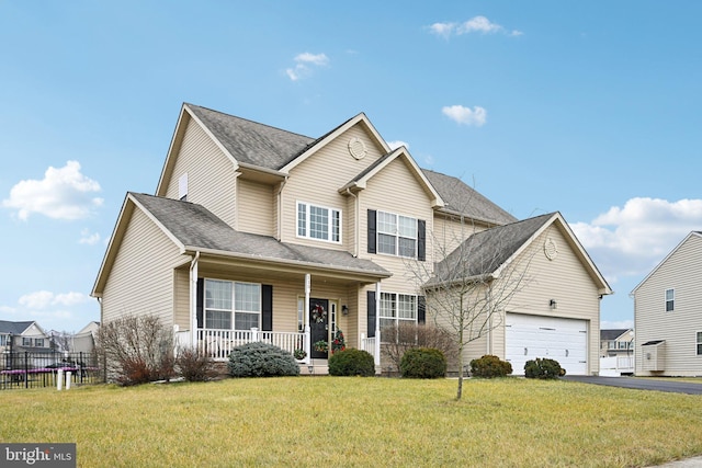 front facade featuring covered porch, a front yard, and a garage