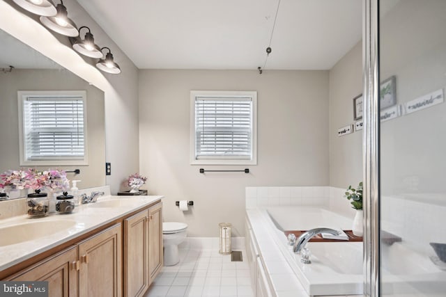 bathroom featuring a tub to relax in, tile patterned flooring, vanity, and a healthy amount of sunlight