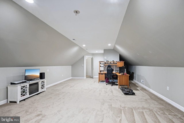 office space featuring light colored carpet and vaulted ceiling