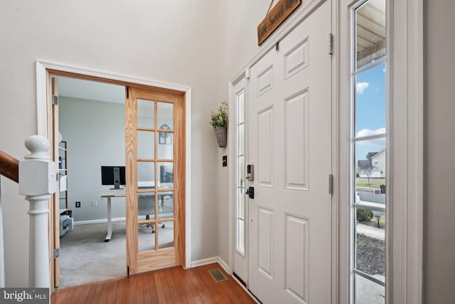 entrance foyer featuring french doors and hardwood / wood-style flooring