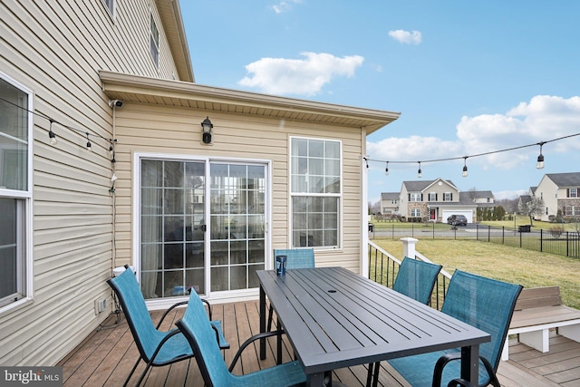 wooden deck featuring a lawn