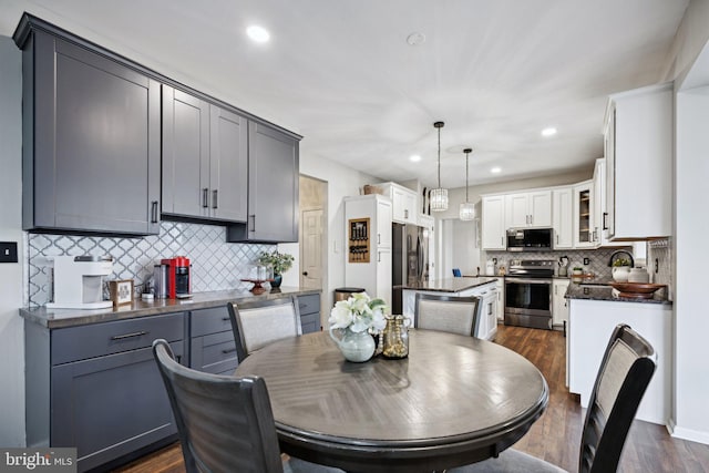 dining space with dark hardwood / wood-style floors