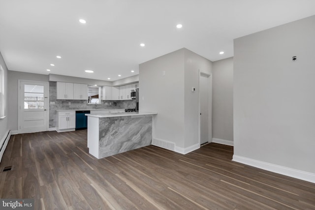 kitchen with white cabinetry, black dishwasher, tasteful backsplash, dark hardwood / wood-style floors, and kitchen peninsula