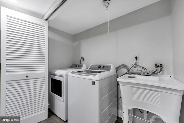 laundry room with separate washer and dryer and sink