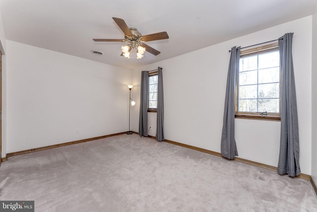 empty room featuring light carpet and ceiling fan