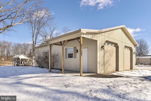 exterior space featuring a garage and an outbuilding