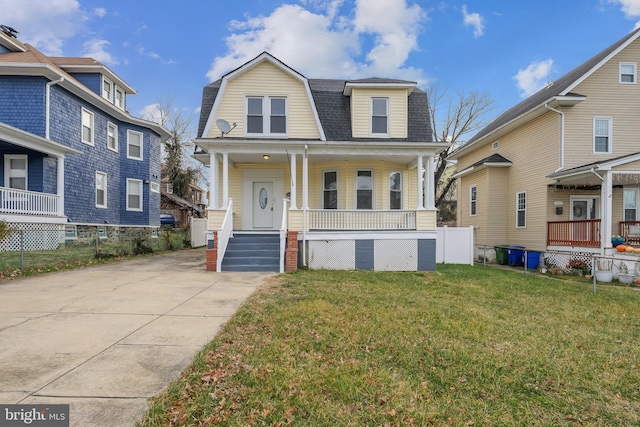 view of front of property with a porch and a front yard