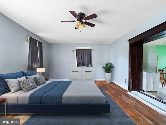 bedroom featuring ceiling fan and dark hardwood / wood-style floors