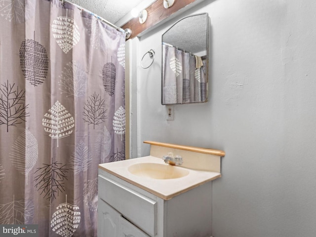 bathroom with vanity and a textured ceiling