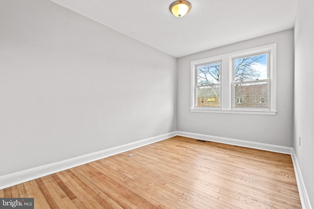 unfurnished room featuring light hardwood / wood-style floors