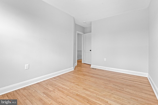 spare room with light hardwood / wood-style floors