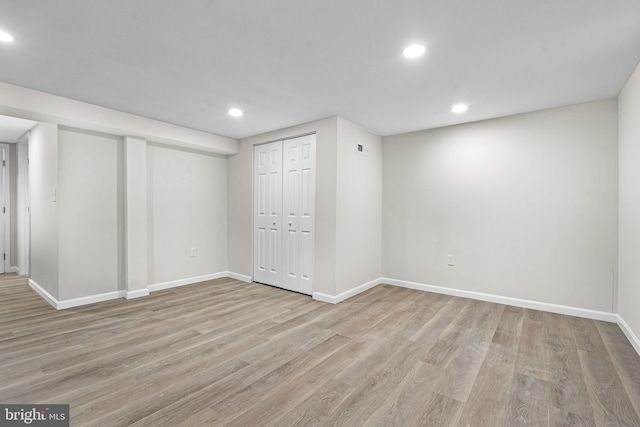 basement with light hardwood / wood-style floors