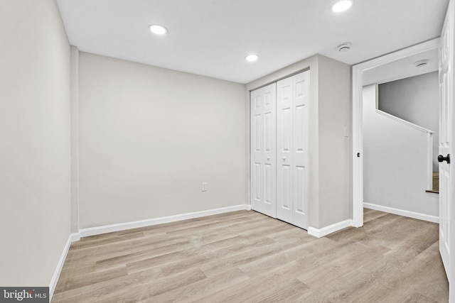 unfurnished bedroom featuring light hardwood / wood-style floors and a closet