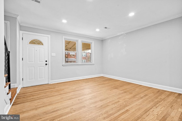 foyer featuring light wood-type flooring and ornamental molding