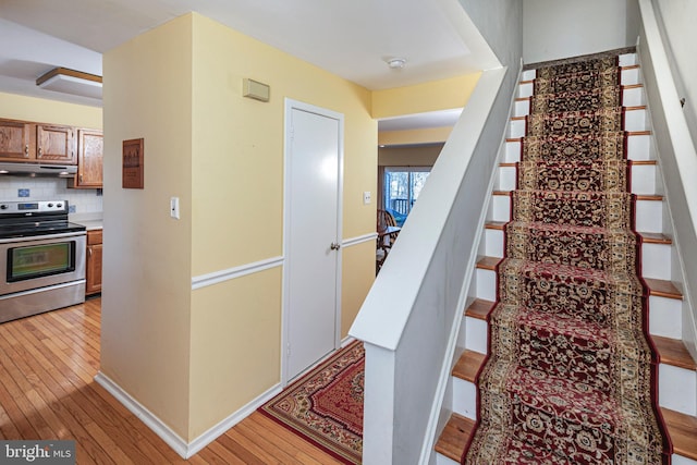 staircase featuring wood-type flooring