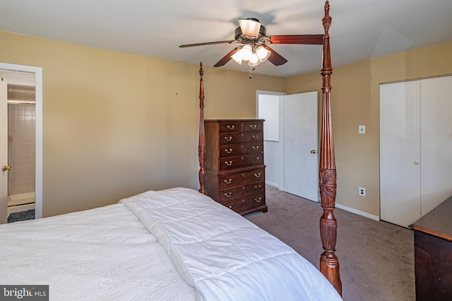 bedroom featuring dark colored carpet, connected bathroom, and ceiling fan