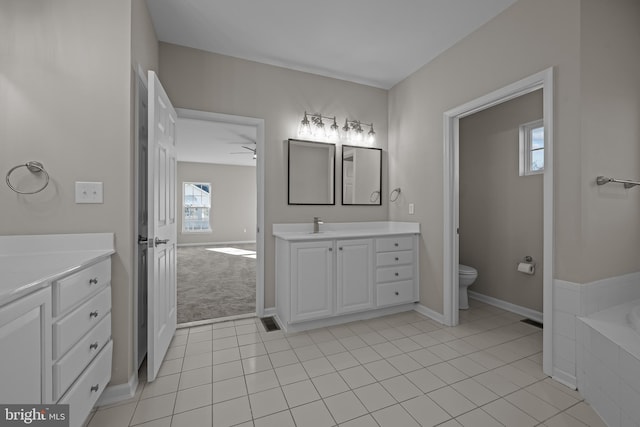 bathroom featuring tile patterned floors, ceiling fan, toilet, and vanity